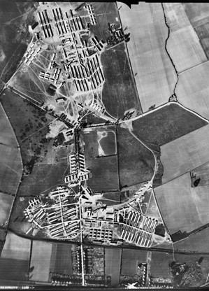 black and white ariel photograph of fields and old military buildings
