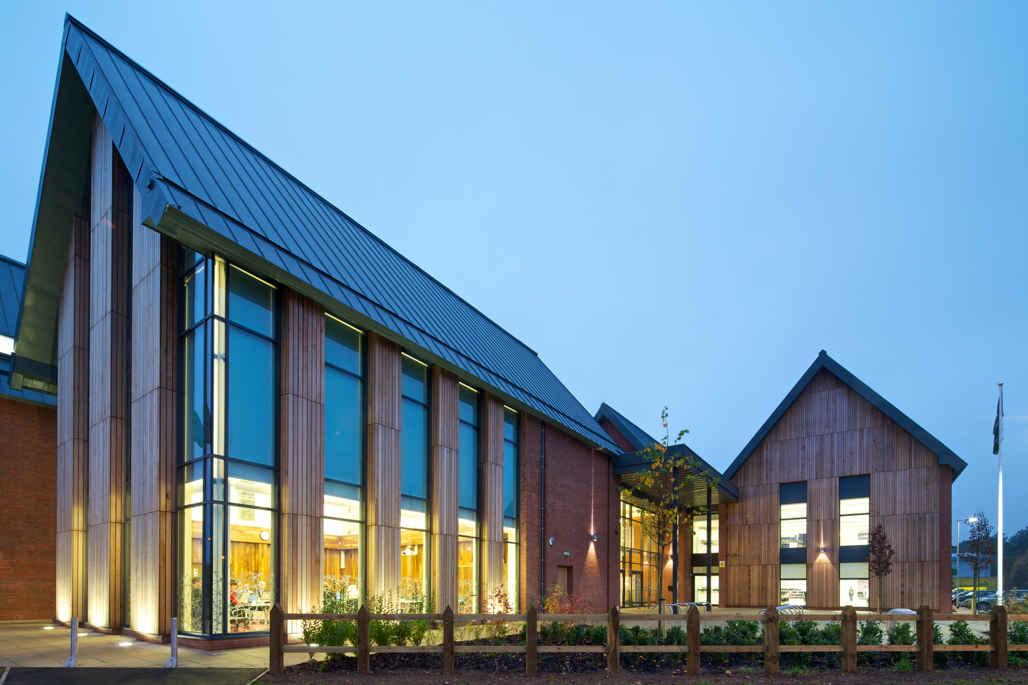 large wood and brick building at dusk