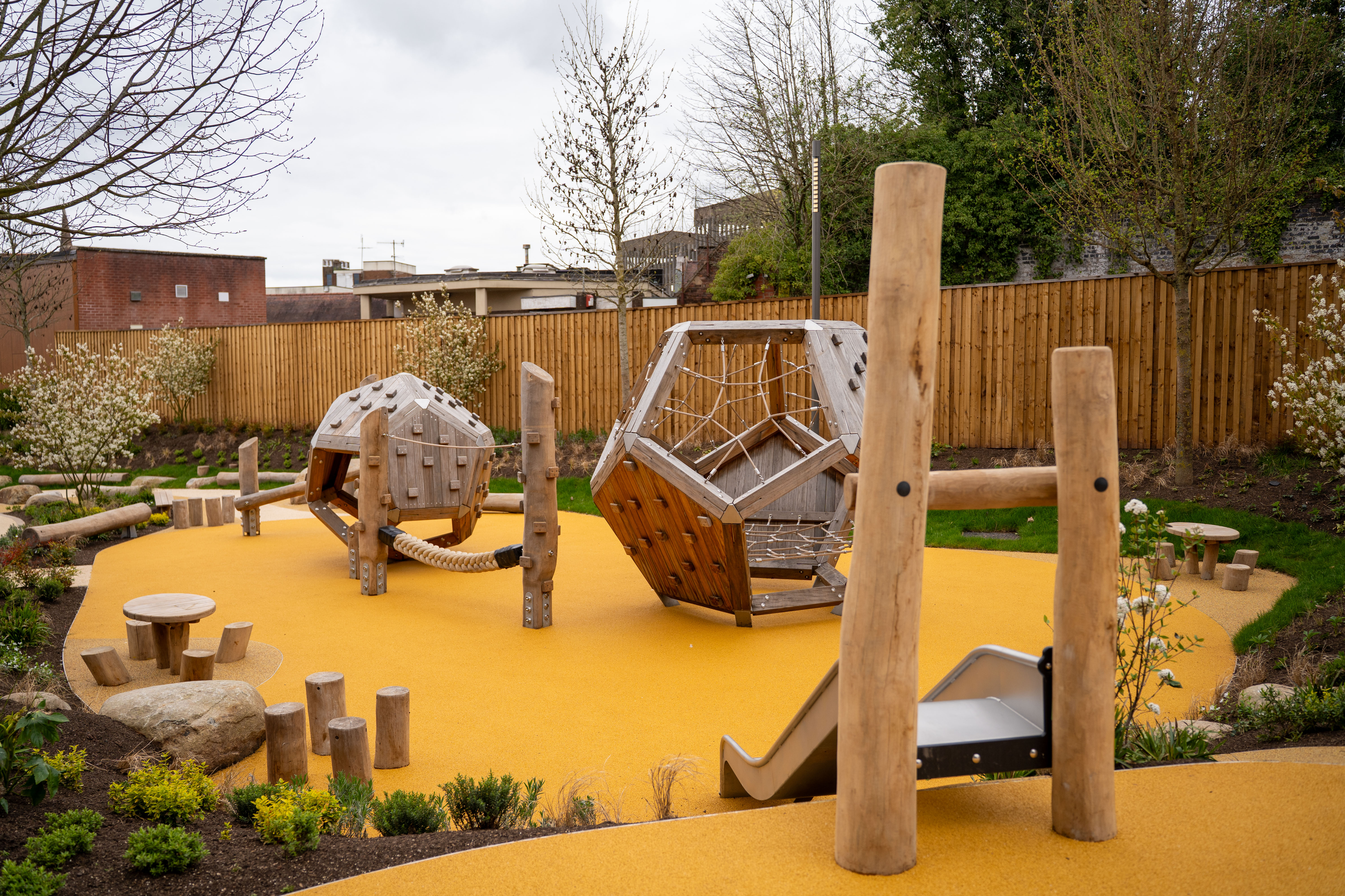 An outdoor play area with a yellow flooring