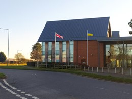 Union and Ukrainian flags flying outside building