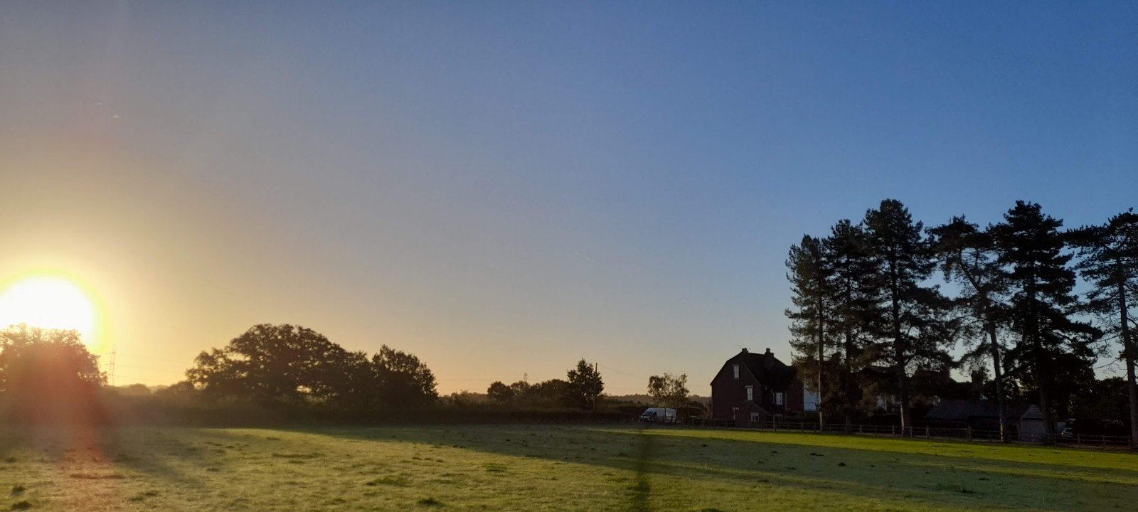 a sunset with trees in the background
